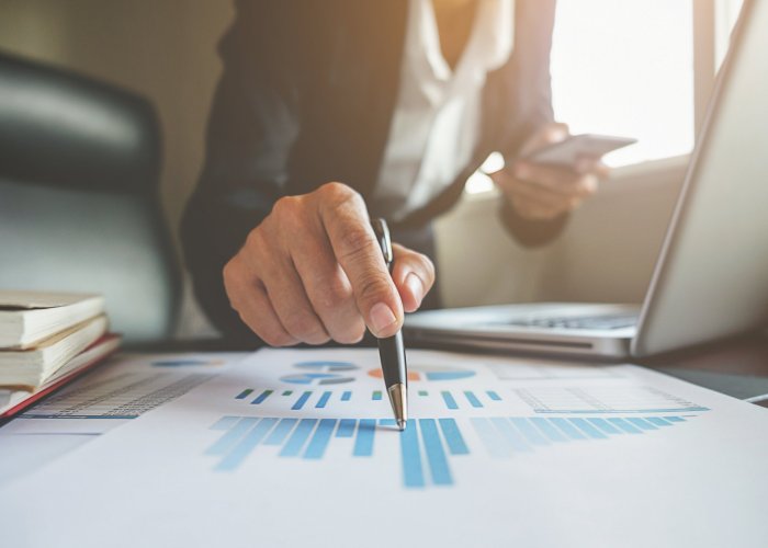 Business concept. Business people discussing the charts and graphs showing the results of their successful teamwork.
